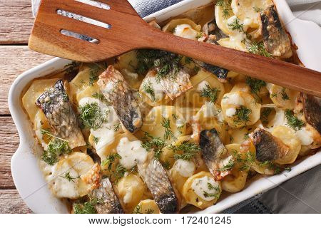 Finnish Food: Casserole With Potatoes And Herring Close Up In Baking Dish. Horizontal Top View