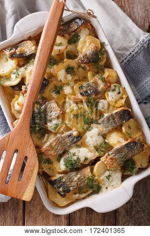 Finnish Food: Casserole With Potatoes And Herring Close Up In Baking Dish. Vertical Top View