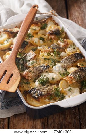 Casserole Of Potatoes, Herring Fish In A Creamy Sauce Close Up In Baking Dish. Vertical