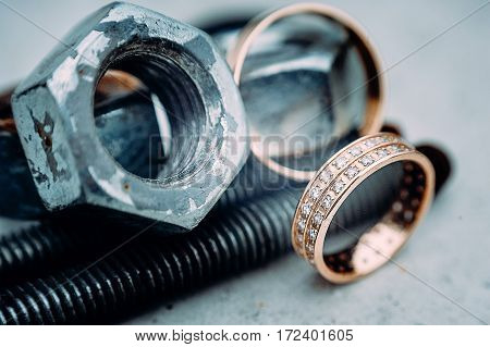 Macro Of Wedding Rings With Diamods On Grey Concrete In Day Light