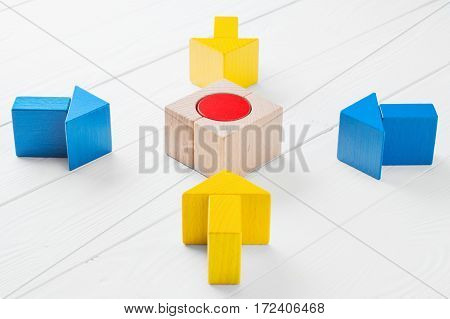 Four wooden arrows converge towards the center target. Arrows pointing to the object. The concept of the goal the implementation of the planned success. Symbol of goal and objective.