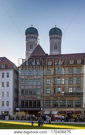 MUNICH, GERMANY - OCTOBER 31, 2015: View on the Marienhof in the city of Munich with unidentified people walking along in the background are the towers of the Frauenkirche