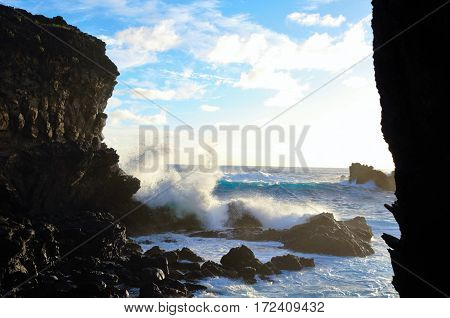Waves breaking at the cliffs in front of the Ana Kai Tangata Cave close to Hanga Roa in Rapa Nui Easter Island in Chile South America