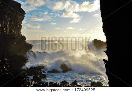 Waves breaking at the cliffs in front of the Ana Kai Tangata Cave close to Hanga Roa in Rapa Nui Easter Island in Chile South America