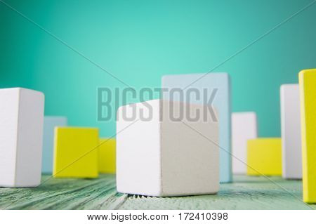 Geometric shapes on a wooden background. Colorful wooden blocks. Business concept creative thinking. Geometric shapes in different colors. Concept of creative logical thinking or problem solving.