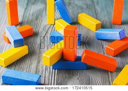 Geometric shapes on a wooden background. Colorful wooden blocks. Business concept creative thinking. Geometric shapes in different colors. Concept of creative logical thinking or problem solving.