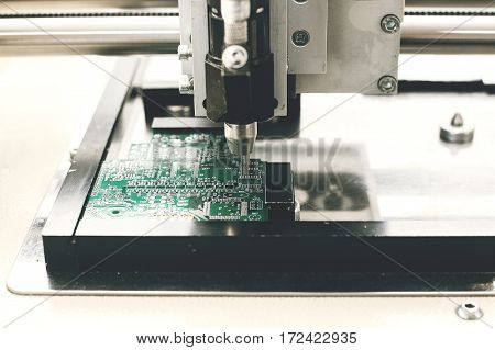 Automation of machine assembly of computer circuit board in the factory for the production of computer components. The process of soldering the board. Factory for the production of microchips.