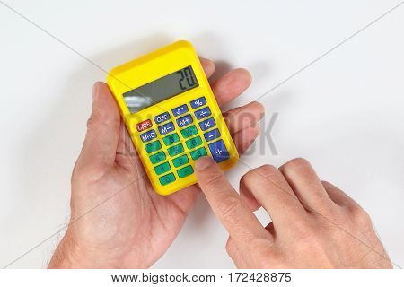 Hands calculate using a calculator on a white background