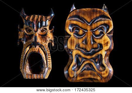 wooden devils mask isolated on black background