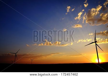 Power generated by wind with winmill blowing sky clouds sunset sunrise