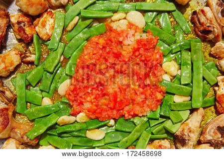 Paella from Spain recipe process ad vegetables green beans and tomato