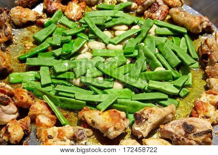 Paella from Spain recipe process ad vegetables green beans and garrofon