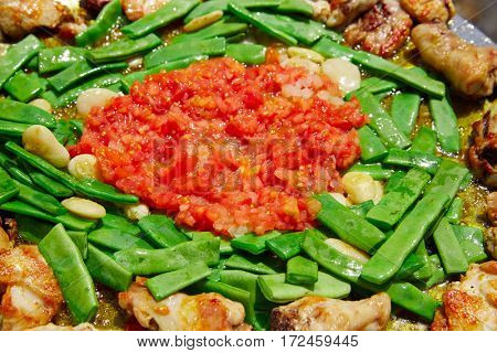 Paella from Spain recipe process ad vegetables green beans and tomato