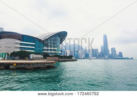 Beautiful super wide-angle summer aerial view View of Hong Kong island skyline, Victoria Bay harbor, with skyscrapers, blue sky and scenery beyond the city, seen from Kowloon island observation Deck