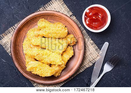 chicken strips on rustic stone background . Top wiew