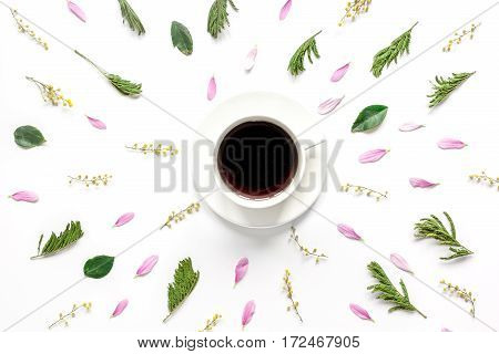 Bright froral pattern with cup of coffee and fresh petals on white table background top view mock-up