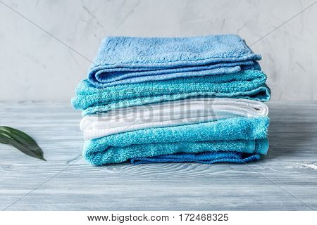 blue towels pile in housekeeping set on laudry gray background mockup