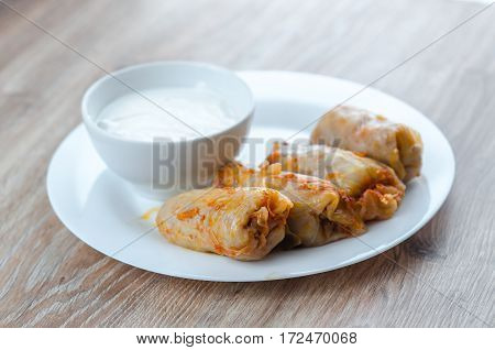 stuffed cabbage - a traditional Ukrainian cuisine braised cabbage leaves stuffed with minced meat and rice with sour cream