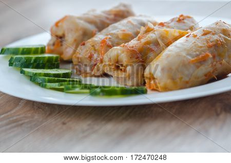 stuffed cabbage is a traditional Ukrainian meals stewed cabbage leaves stuffed with ground meat and rice with sour cream with sliced cucumbers