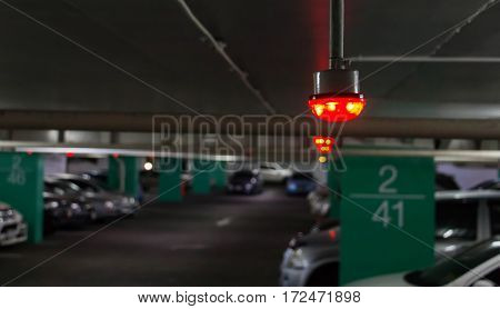red light over occupied lot in parking