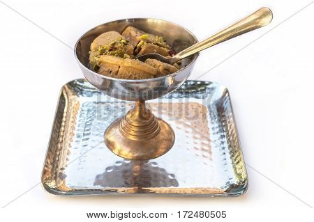 A photo of kulfi, traditional Indian ice cream, in a typical bowl, on white background. Selective focus