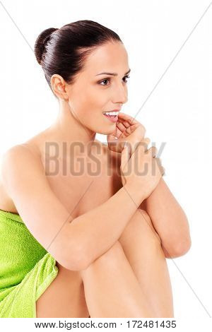 Beautiful woman in towel sitting on the floor