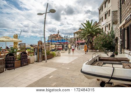 PETROVAC, MONTENEGRO - SEPTEMBER 20, 2016:Tourists walk along the promenade in Petrovac, Montenegro.