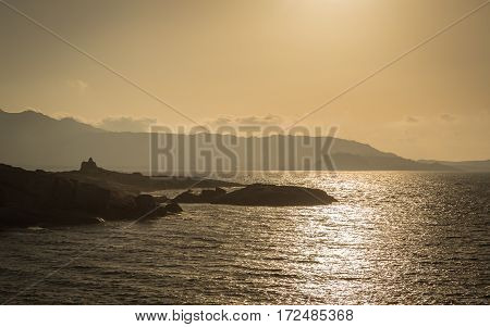 Sun Setting Over A Genoese Tower And Calvi In Corsica