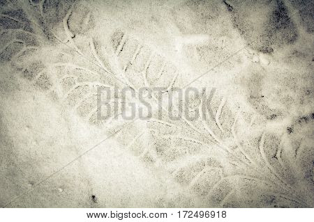 Diagonal traces of car tires on the snow. Close up view from above