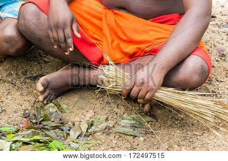 DABANA, SRI LANKA - CIRCA DECEMBER 2016: Vedda men making fire. Veddas are an indigenous people of Sri Lanka living in tribes in the jungle