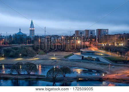 NARVA, ESTONIA - JANUARY 1, 2017: Night view of the city with beach on Narova River and Alexander Lutheran Cathedral