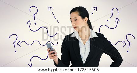 Businesswoman using mobile phone against grey background