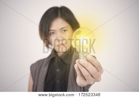 Business women hand holding light bulb concept of new ideas with innovation and creativity.