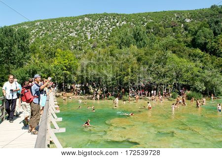 Tourists Walking And Swimming At The Krka National Park