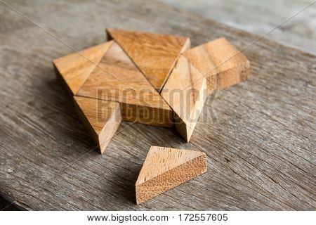 Wooden tangram puzzle wait to fulfill home shape for build dream home or happy life concept