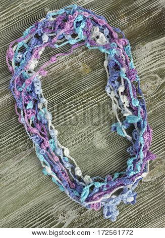 Handmade crocheted cotton organic lace wreath. White crochet frame Knitted pattern handicraft background needlework creative craft. Bright crochet wreath with flowers place for text