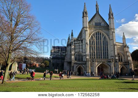 WINCHESTER, UK - FEBRUARY 4, 2017: Exterior view of the Cathedral with people enjoying a sunny winter day
