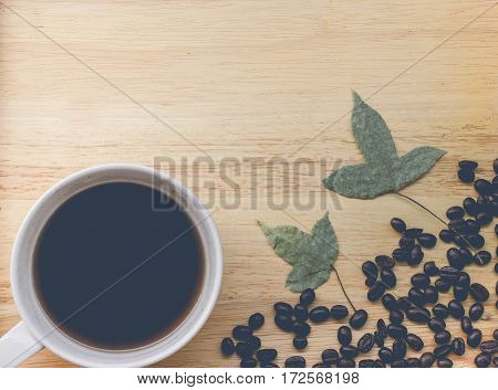 coffee bean and coffee mug on wood background