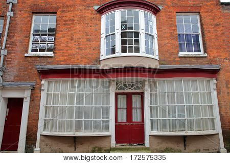 WINCHESTER, UK - FEBRUARY 5, 2017:  Exterior facade of a house on Kingsgate Street with a colorful brick wall and large windows