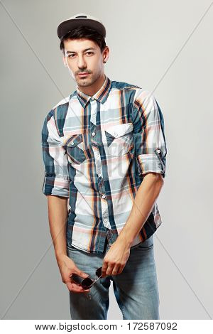 stylish handsome young man posing at studio fashion shoot
