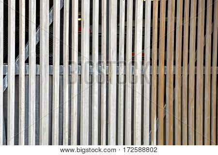 Close-up of pattern and texture and verticle planks of slatted wooden gate barrier
