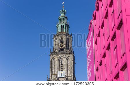 GRONINGEN, NETHERLANDS - FEBRUARY 15, 2017: Martini tower and pink building in the center of Groningen, Holland