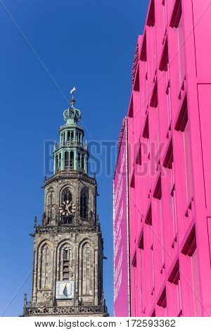 GRONINGEN, NETHERLANDS - FEBRUARY 15, 2017: Martini tower and pink building in the center of Groningen, Holland