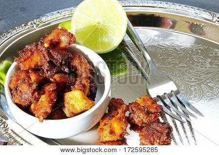 Chicken 65 an Indian appetizer chicken morsels in spicy mix and deep fried in oil selective focus.