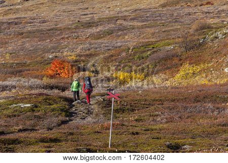 BJORKLIDEN, SWEDEN ON 21 SEPTEMBER. View of a mountain trail, track on September 21, 2016 in Bjorkliden, Sweden. Unidentified couple on is way up the track. Editorial use.