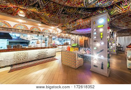 MOSCOW - AUGUST 2014: Interior Chaihana Lounge Eastern restaurant in a traditional style. The main dining room with an open kitchen with colorful fabric ceiling with ethnic patterns