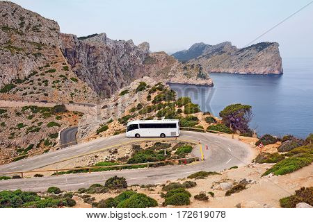 Tourist bus on the mountain road of the Cape Formentor as seen from the Formentor lighthouse. Island Majorca, Spain.