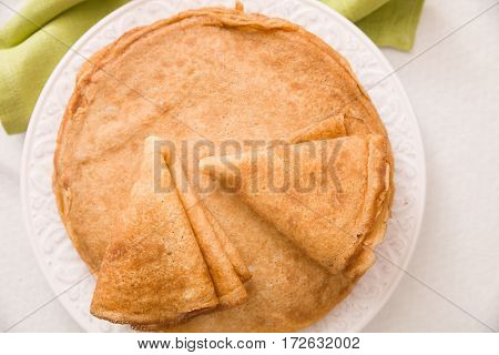 Top view on pancakes on the plate. Dessert and homemade snacks. Healthy eating.