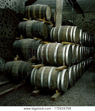 Wine Barrels Stacked In The Old Cellar Of The Winery.