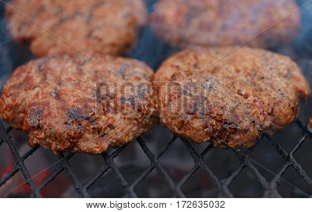 Beef or pork meat barbecue burgers for hamburger prepared grilled on bbq fire flame grill
